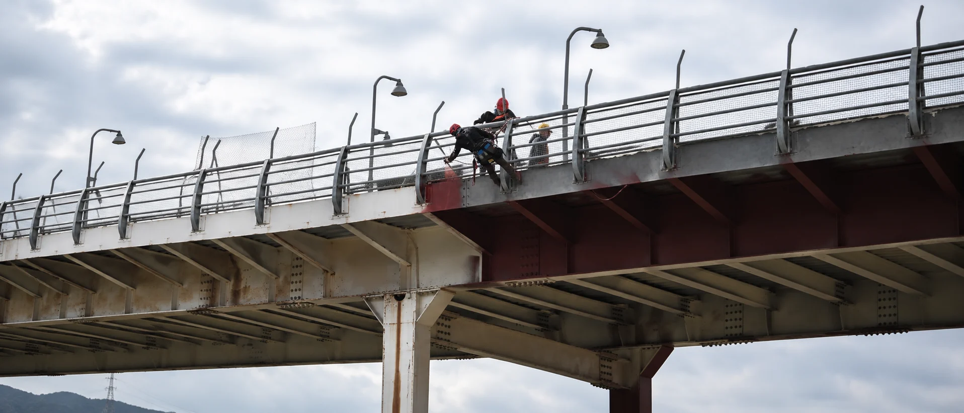 Rope-access technician working on a bridge